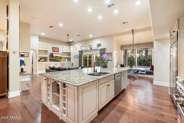 kitchen with sink, hardwood / wood-style floors, and a center island with sink