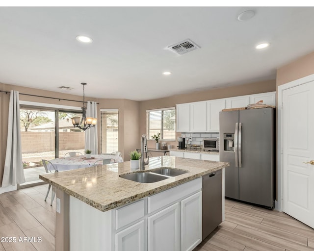 22337 E Via Del Palo, Queen Creek, AZ 85142 - kitchen with white cabinets, a sink, stainless steel appliances, and visible vents