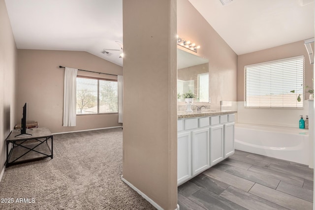 22337 E Via Del Palo, Queen Creek, AZ 85142 - full bathroom featuring lofted ceiling, visible vents, a garden tub, and vanity