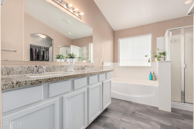 22337 E Via Del Palo, Queen Creek, AZ 85142 - bathroom with a stall shower, double vanity, a bath, and a sink