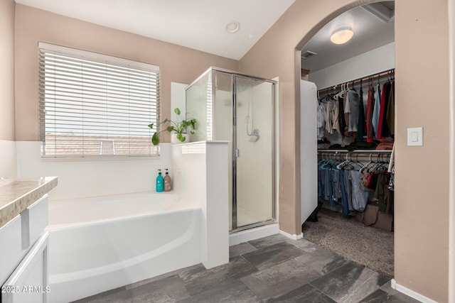 22337 E Via Del Palo, Queen Creek, AZ 85142 - bathroom featuring a bath, a walk in closet, and a shower stall