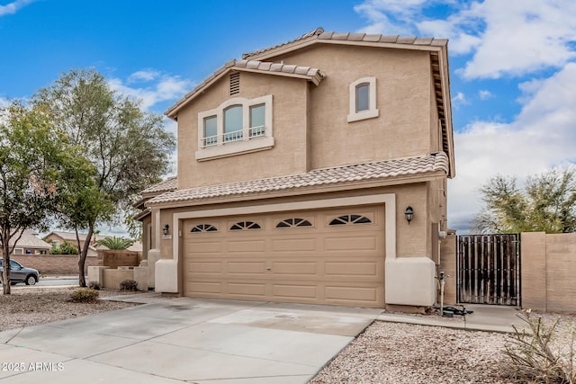 22337 E Via Del Palo, Queen Creek, AZ 85142 - view of front of home with a gate, concrete driveway, stucco siding, an attached garage, and a tiled roof