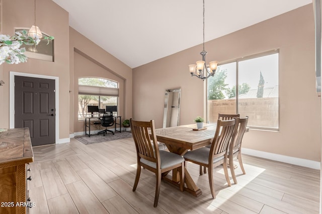 22337 E Via Del Palo, Queen Creek, AZ 85142 - dining space featuring baseboards, high vaulted ceiling, light wood-style flooring, and a chandelier
