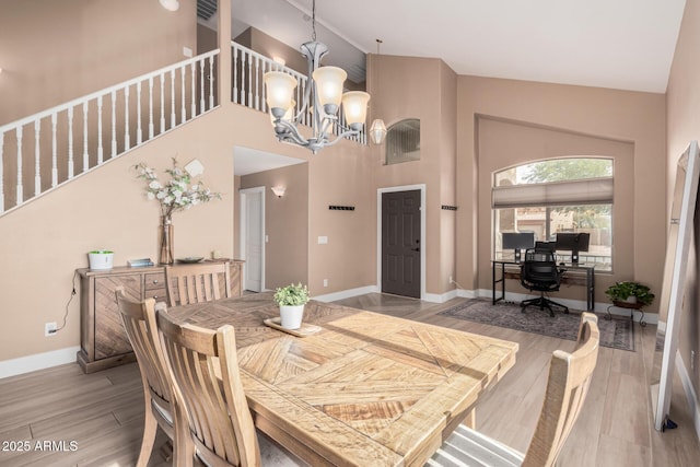 22337 E Via Del Palo, Queen Creek, AZ 85142 - dining space with high vaulted ceiling, baseboards, a chandelier, and wood finished floors