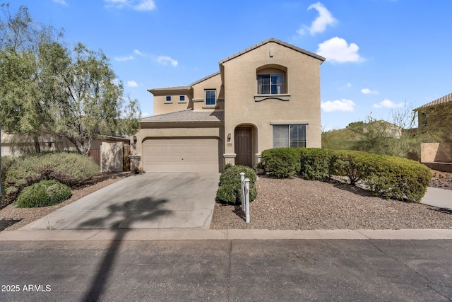 mediterranean / spanish home featuring a garage, a tile roof, concrete driveway, and stucco siding