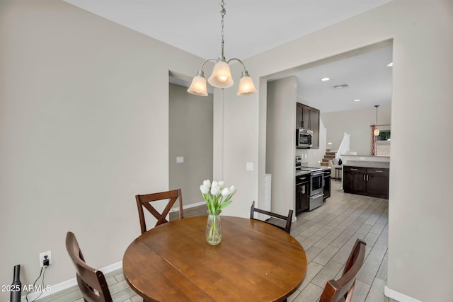 dining room featuring wood finish floors, visible vents, baseboards, and recessed lighting