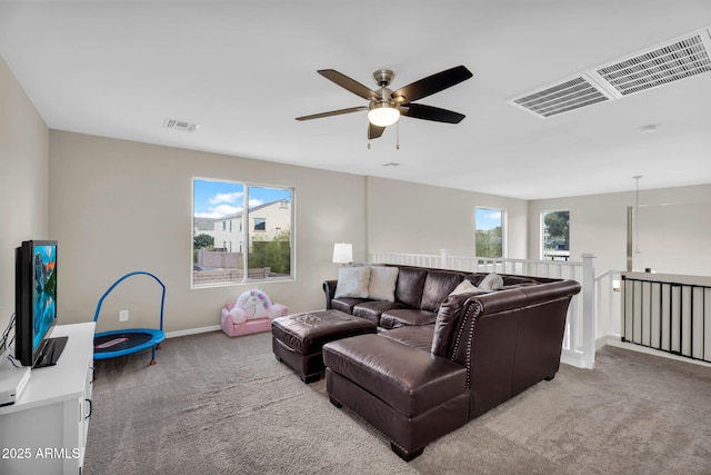 living area with carpet floors, visible vents, and a ceiling fan