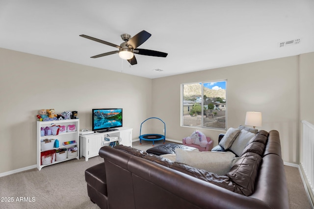 living area with baseboards, visible vents, and carpet flooring