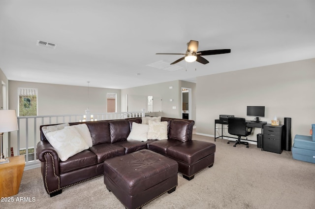 living room with carpet floors, visible vents, ceiling fan, and baseboards