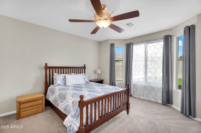 bedroom featuring baseboards, visible vents, ceiling fan, and light colored carpet