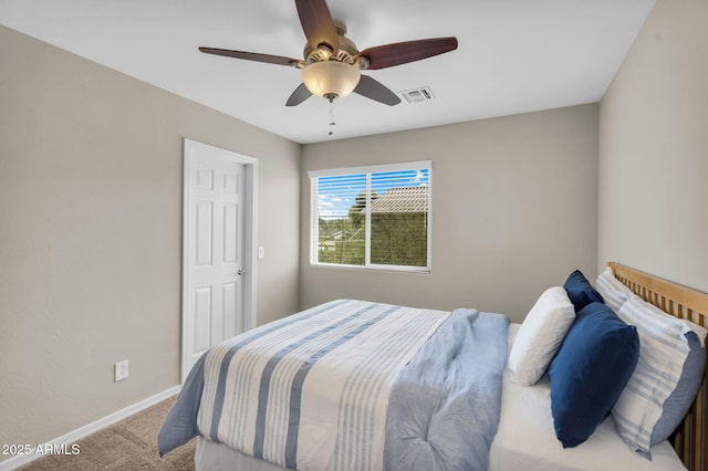 carpeted bedroom featuring visible vents, ceiling fan, and baseboards