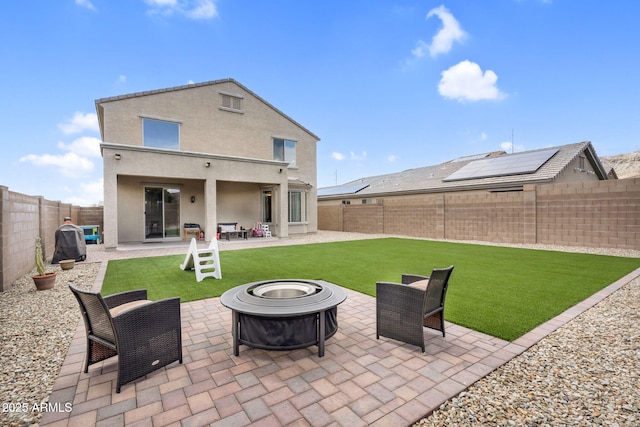 back of property featuring a patio, an outdoor fire pit, a fenced backyard, a yard, and stucco siding