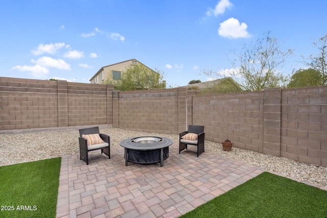 view of patio / terrace with an outdoor fire pit and a fenced backyard