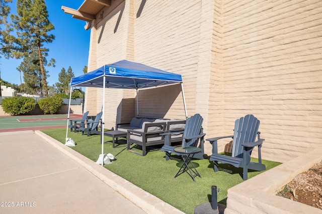 view of patio featuring basketball hoop and outdoor lounge area