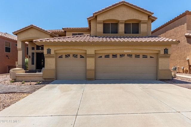 mediterranean / spanish-style house with a garage