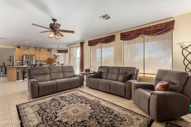 living room featuring light tile patterned floors and ceiling fan