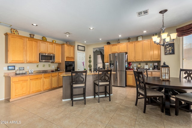 kitchen featuring an inviting chandelier, appliances with stainless steel finishes, light tile patterned flooring, pendant lighting, and a center island with sink