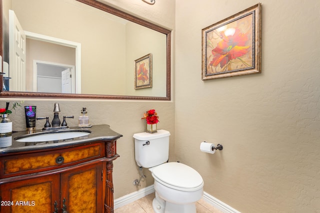 bathroom with vanity, toilet, and tile patterned floors