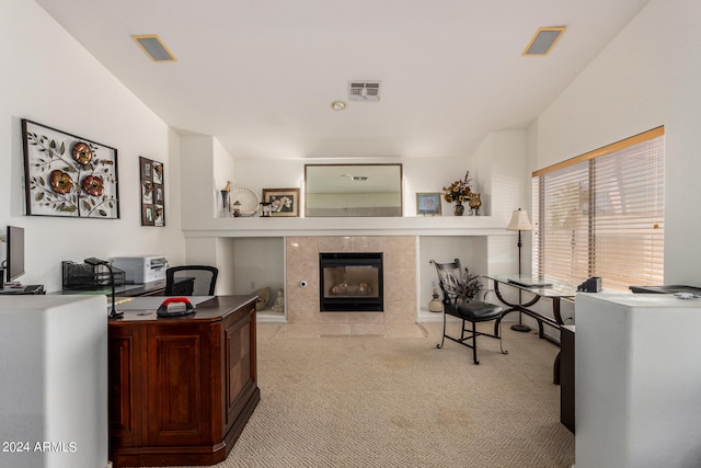 carpeted office space featuring a tile fireplace