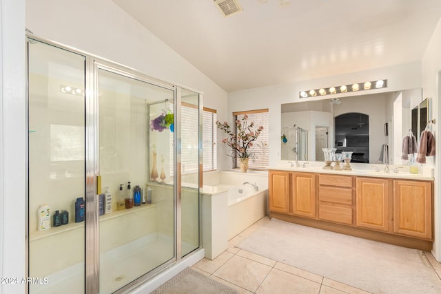 bathroom featuring vanity, vaulted ceiling, tile patterned floors, and plus walk in shower