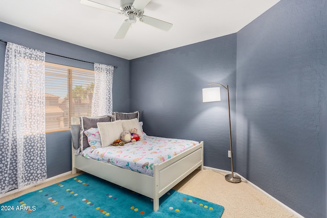 bedroom featuring ceiling fan and carpet