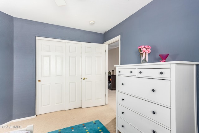 bedroom featuring a closet and light carpet