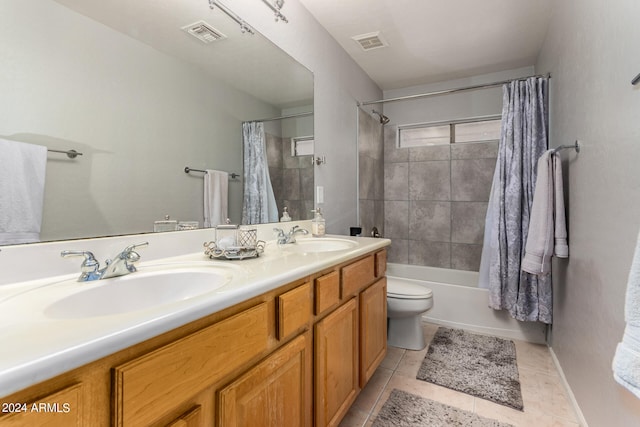 full bathroom with tile patterned flooring, shower / bath combination with curtain, toilet, and vanity