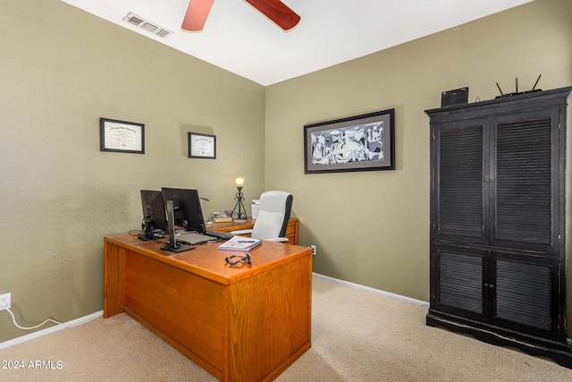 home office featuring light carpet and ceiling fan