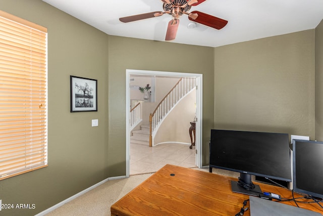 carpeted home office featuring plenty of natural light and ceiling fan