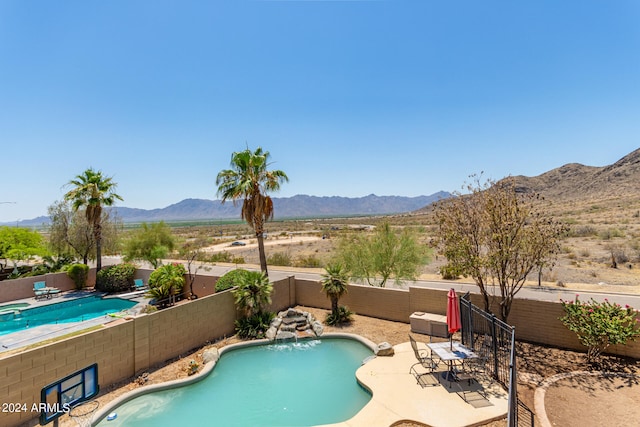 view of swimming pool featuring a mountain view and a patio area