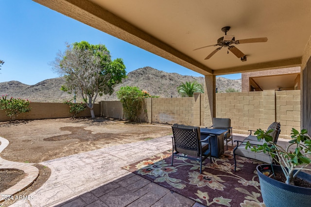 view of patio featuring a mountain view and ceiling fan