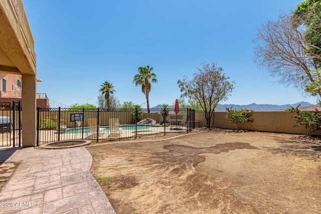 view of yard featuring a fenced in pool and a mountain view