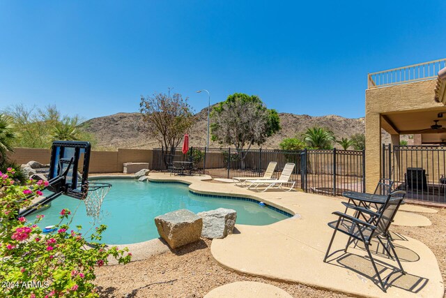 view of yard with a fenced in pool, a patio, and ceiling fan