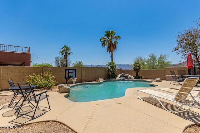 view of swimming pool featuring pool water feature and a patio area