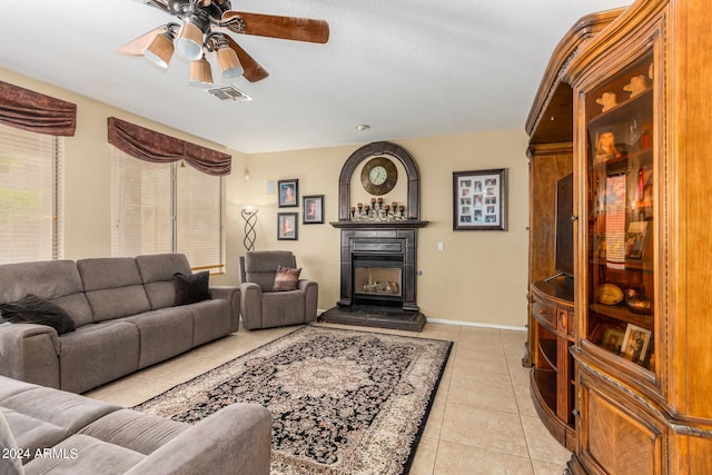 living room featuring ceiling fan and light tile patterned floors