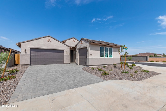 view of front of property featuring a mountain view and a garage