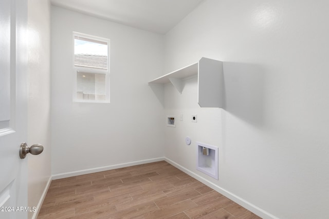 clothes washing area featuring washer hookup, hookup for an electric dryer, hookup for a gas dryer, and light hardwood / wood-style flooring