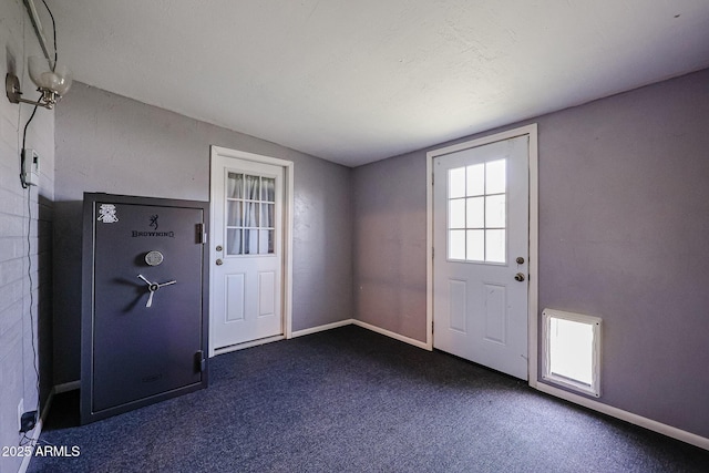 doorway to outside featuring dark carpet