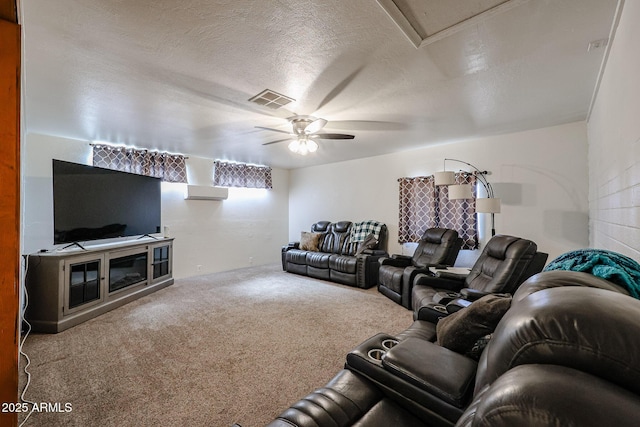 carpeted living room with ceiling fan and a textured ceiling