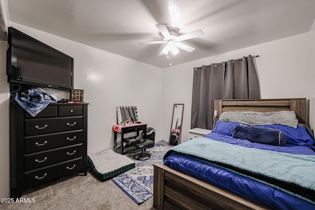 carpeted bedroom featuring a textured ceiling and ceiling fan