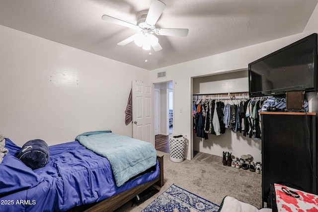 carpeted bedroom with a closet and ceiling fan