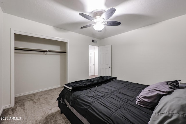 bedroom with light colored carpet, a closet, and ceiling fan