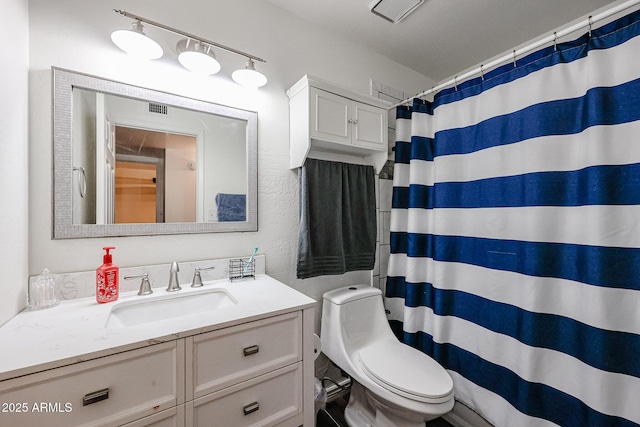 bathroom with vanity, a shower with curtain, and toilet