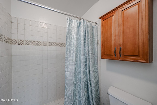 bathroom featuring curtained shower and toilet