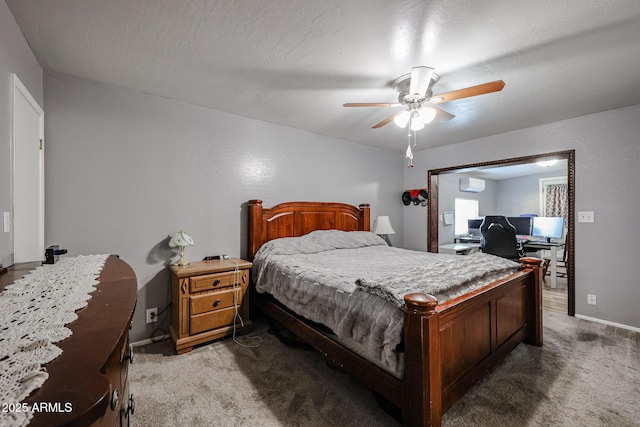 bedroom featuring carpet flooring, a wall mounted air conditioner, a textured ceiling, and ceiling fan