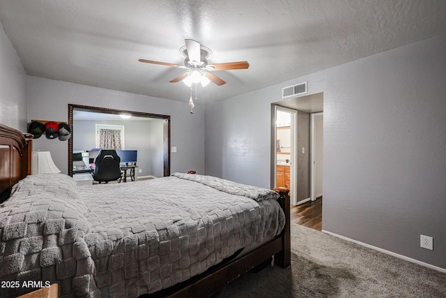 bedroom featuring a textured ceiling, ceiling fan, and dark colored carpet