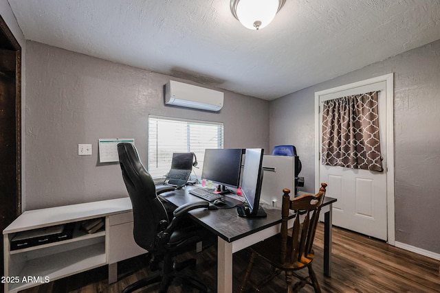 home office with dark hardwood / wood-style flooring, a textured ceiling, and an AC wall unit