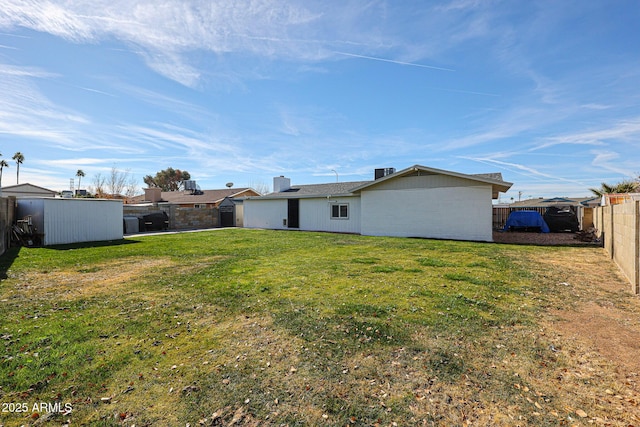 back of house featuring a yard