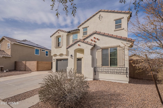 mediterranean / spanish home with a garage, driveway, a tile roof, and stucco siding