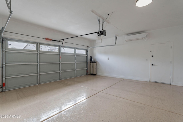 garage featuring baseboards, an AC wall unit, and a garage door opener